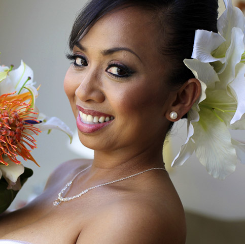 Sally holding her Hawaiian lilly protea bouquet with large white flower in the hair